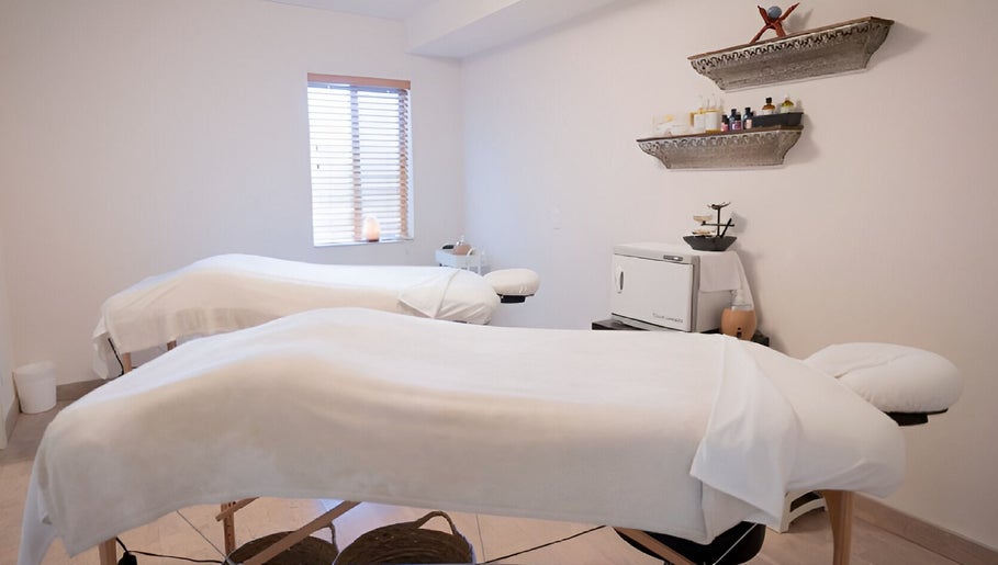 Massage room with two tables at Spirit Water Spa, Ainsworth, British Columbia, CA, offering a serene environment.