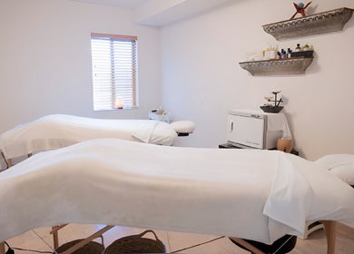 Massage room with two tables at Spirit Water Spa, Ainsworth, British Columbia, CA, offering a serene environment.