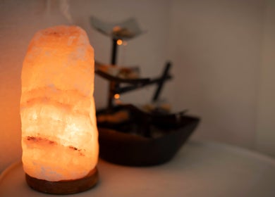 Himalayan salt lamp glowing warmly in Spirit Water Spa, Ainsworth, British Columbia, CA. A serene spa atmosphere.
