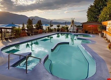 Poolside view at Spirit Water Spa, showcasing sunset over Ainsworth, British Columbia, CA.