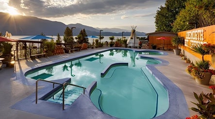 Poolside view at Spirit Water Spa, showcasing sunset over Ainsworth, British Columbia, CA.