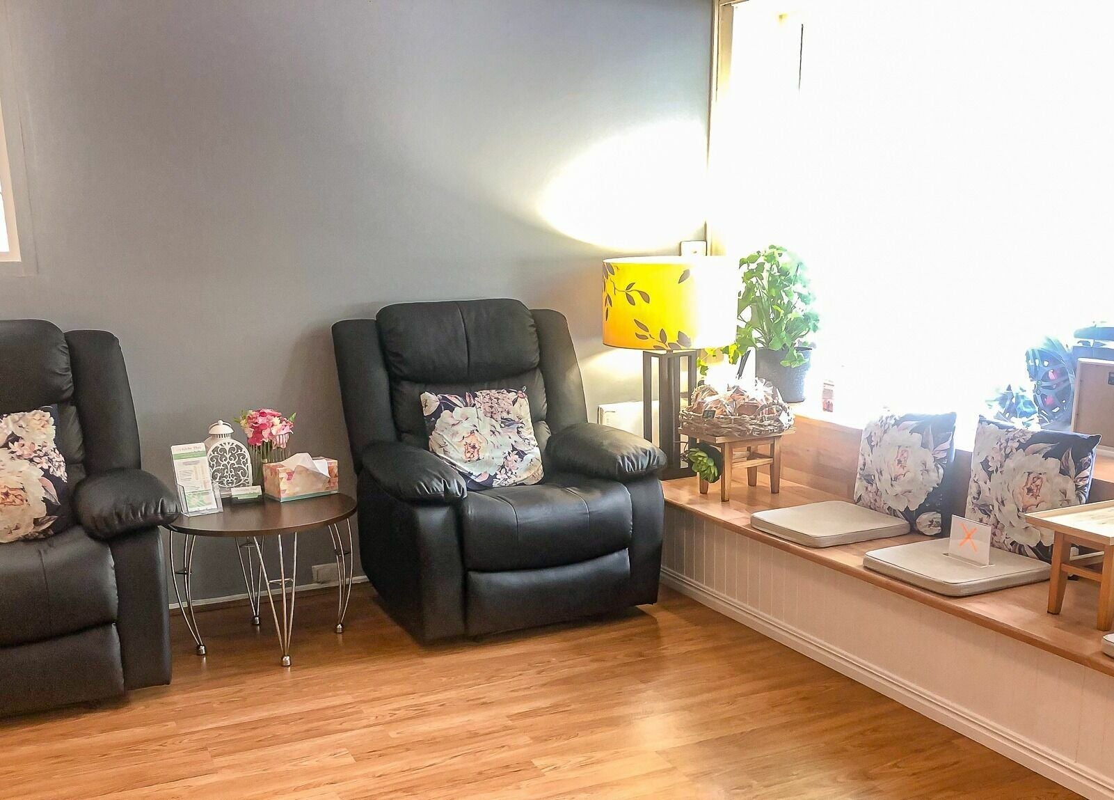 Cozy seating at Glebe Thai Therapeutic Massage in Glebe, New South Wales, AU with floral cushions and soft lighting.