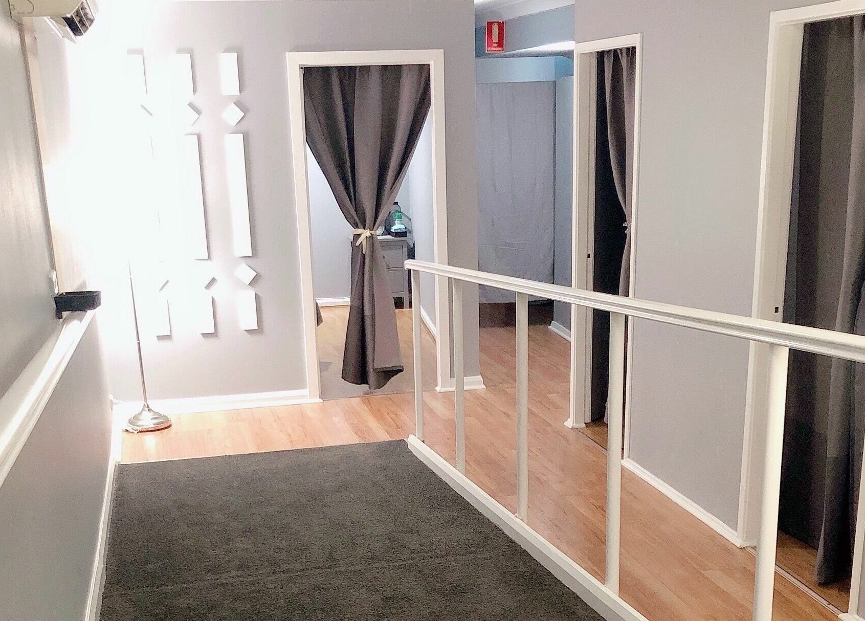 Bright corridor with therapy rooms at Glebe Thai Therapeutic Massage, Glebe, New South Wales, AU.