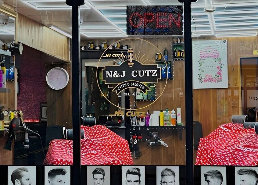 Interior of N & J Cutz, Coventry, England, GB showcasing stylish barber chairs and grooming products.