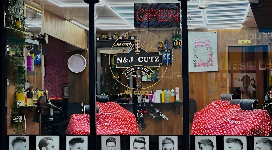 Interior of N & J Cutz, Coventry, England, GB showcasing stylish barber chairs and grooming products.