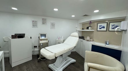 Modern treatment room at Art&Beauty, London, England, GB, featuring a plush bed and professional equipment.