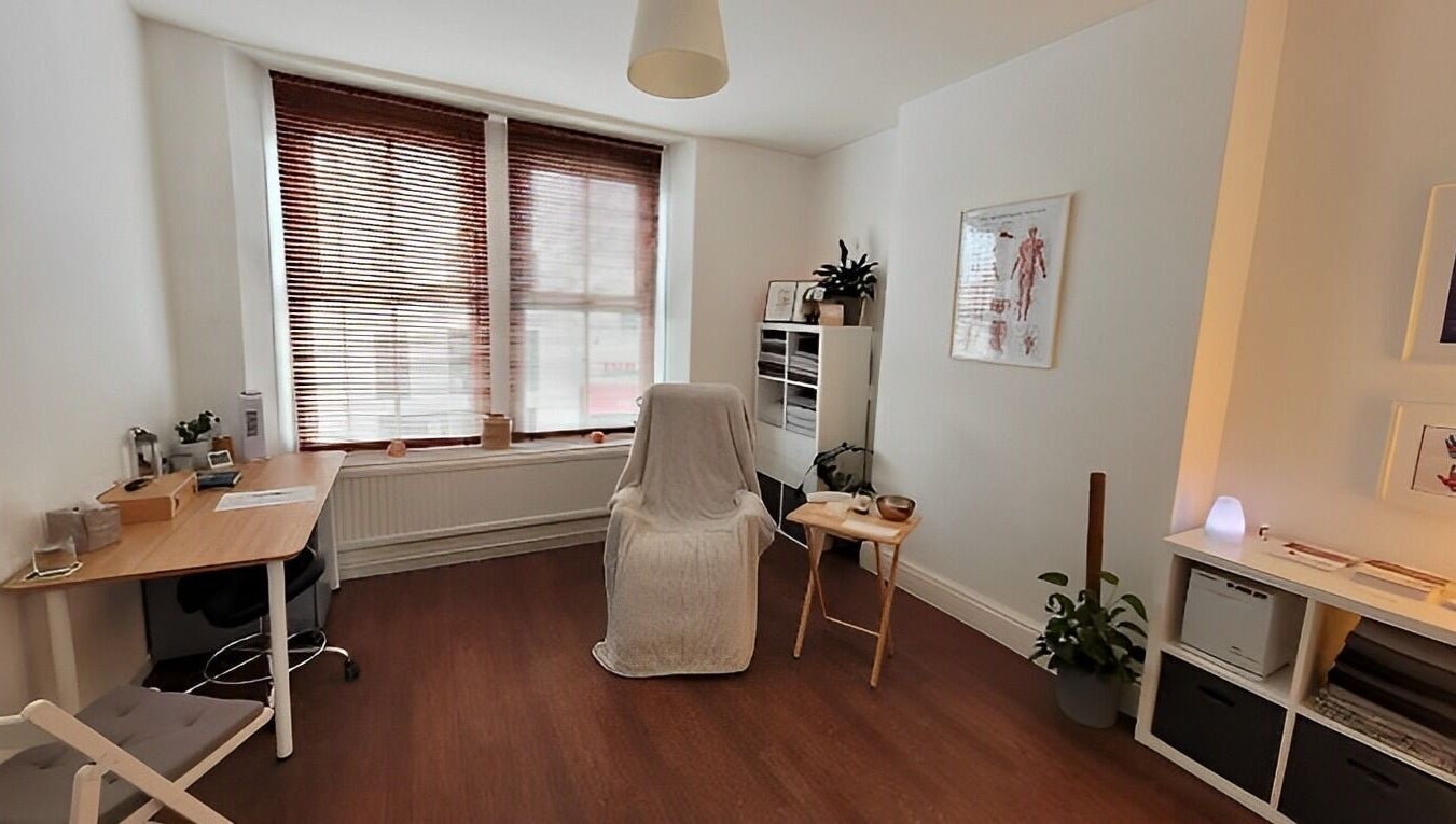 A serene therapy room at Bethan Owen Complementary Healthcare in Cardiff Bay, Wales, GB, with warm wooden accents.