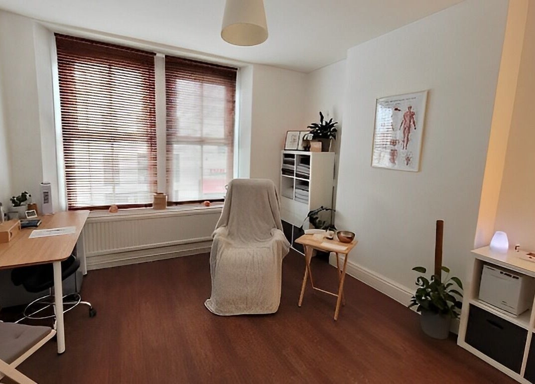 A serene therapy room at Bethan Owen Complementary Healthcare in Cardiff Bay, Wales, GB, with warm wooden accents.