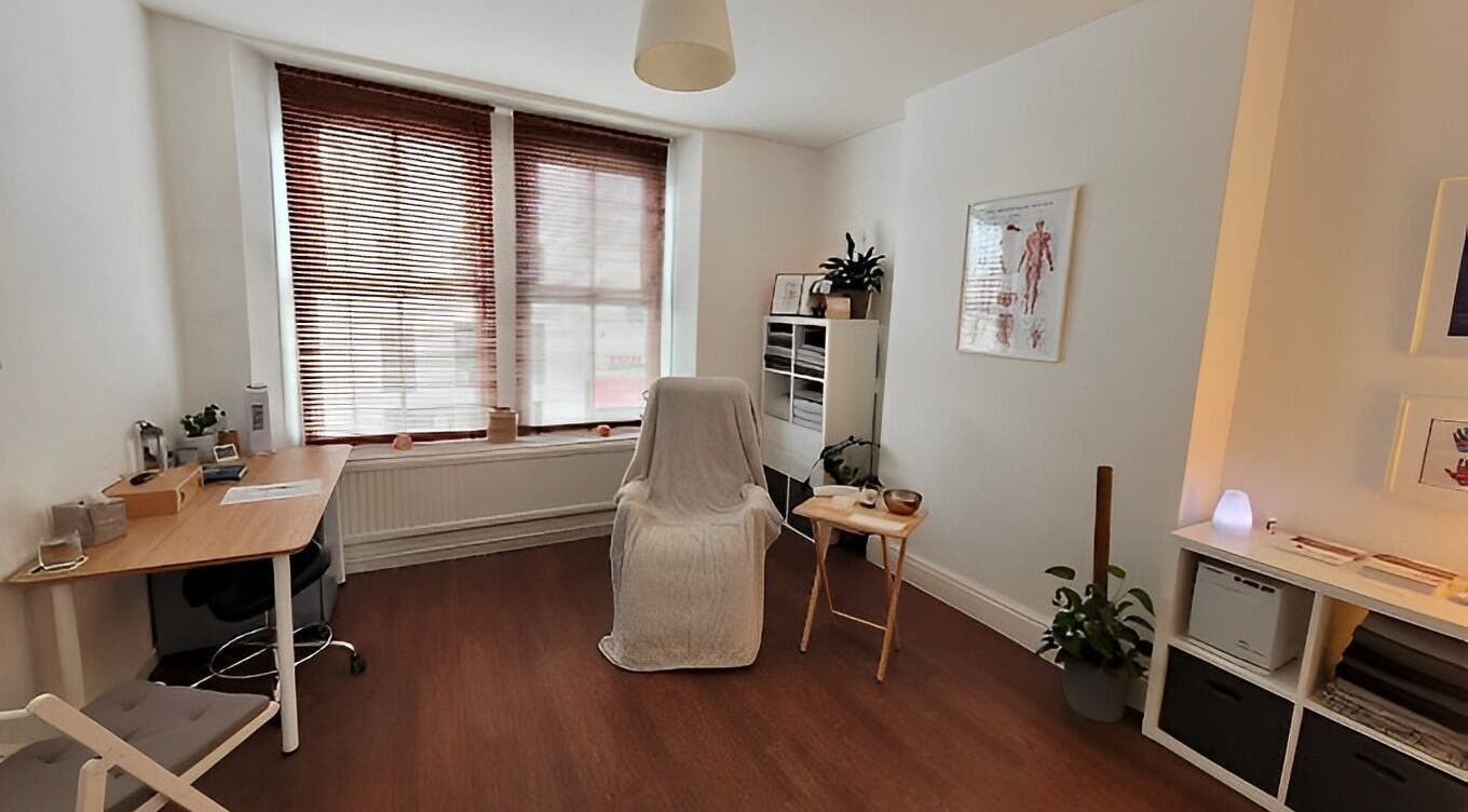 A serene therapy room at Bethan Owen Complementary Healthcare in Cardiff Bay, Wales, GB, with warm wooden accents.