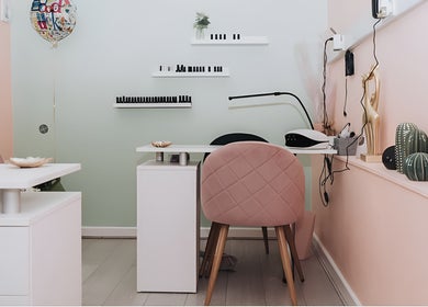 Stylish workstation at Kate Darby - Hair Designer in Stoke-on-Trent, England, GB with pink decor.