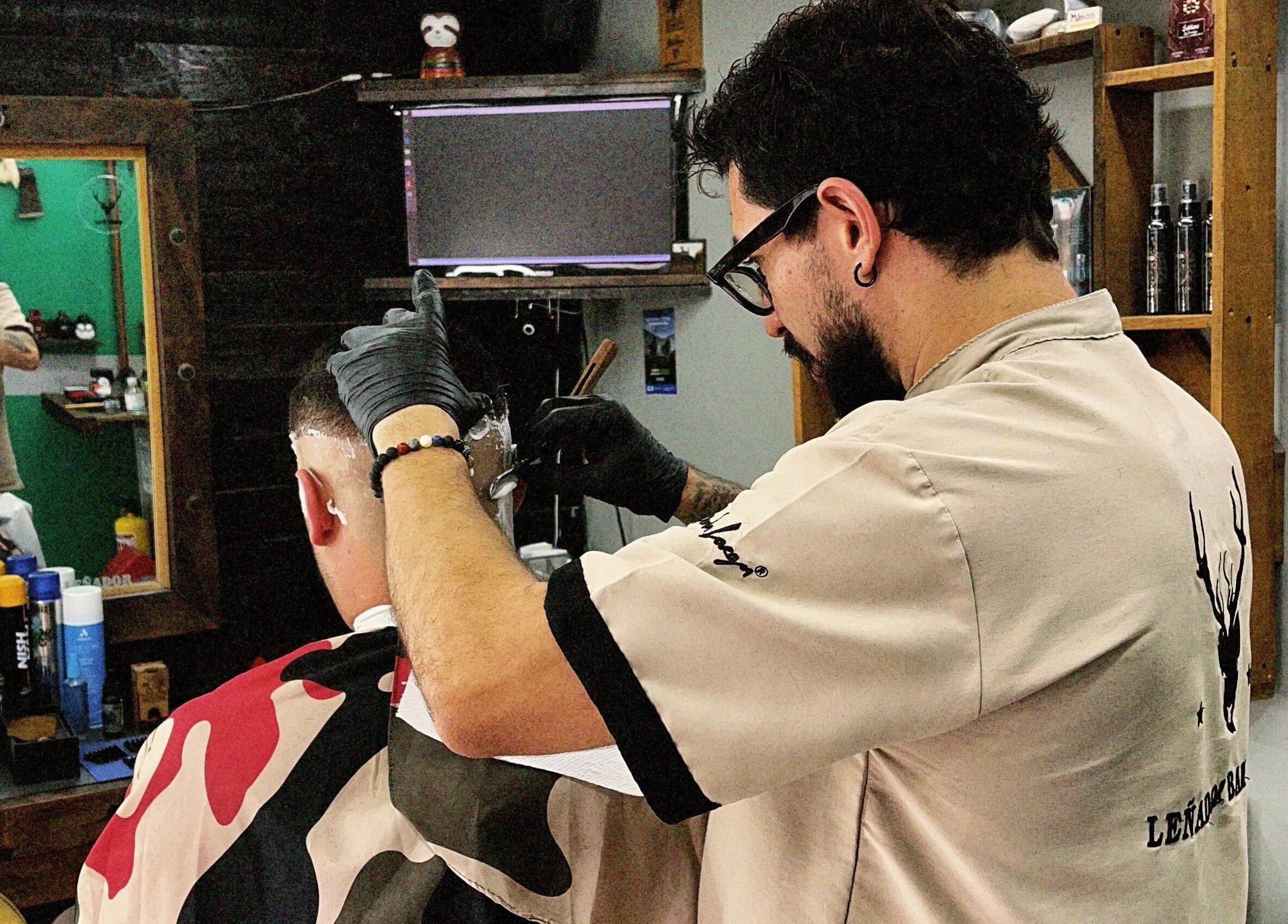 Barbero en Leñador Barber en MANIZALES, Caldas, CO, cortando cabello con profesionalismo.