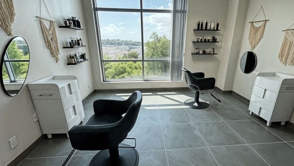 Chic salon interior at Well Now HairCare in Lake Forest, California, with modern chairs and natural light.