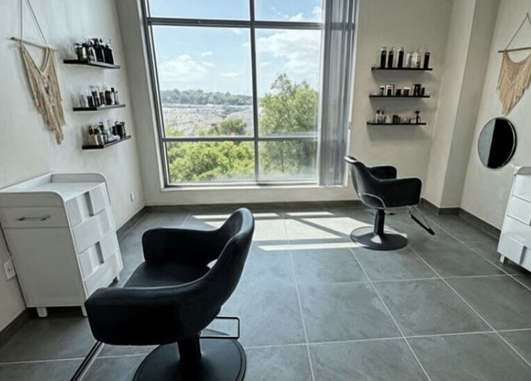 Chic salon interior at Well Now HairCare in Lake Forest, California, with modern chairs and natural light.