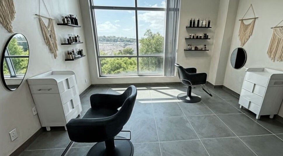 Chic salon interior at Well Now HairCare in Lake Forest, California, with modern chairs and natural light.