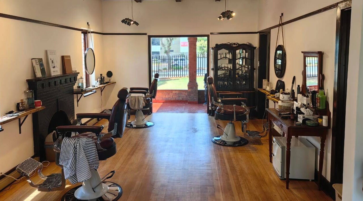Chic barber chairs and mirrors in Bolton House, Johannesburg, Gauteng, ZA, showcasing elegant interior design.