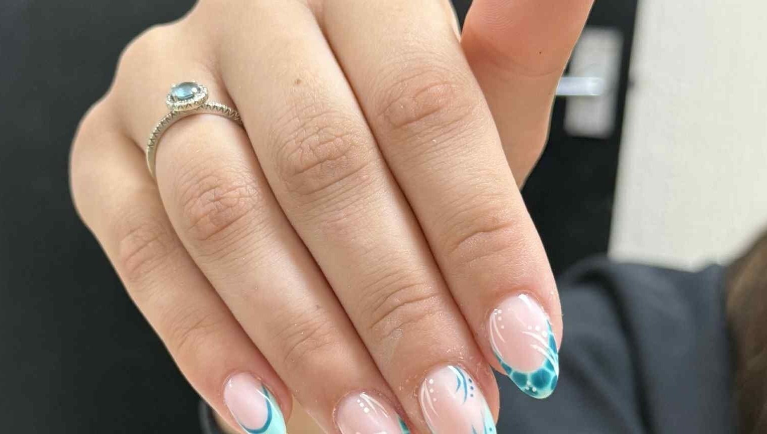 Detailed view of elegant blue nail art with intricate designs at Beauty Lounge, Bargoed, Wales, GB.