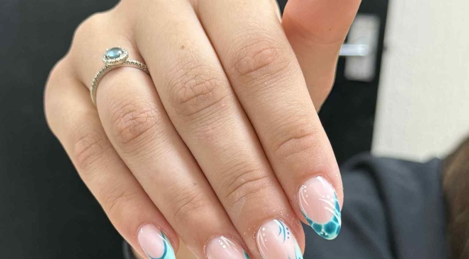 Detailed view of elegant blue nail art with intricate designs at Beauty Lounge, Bargoed, Wales, GB.