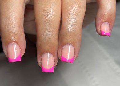Vibrant pink French manicure nails at Beauty Lounge, Bargoed, Wales, GB.