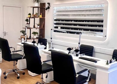 Luxurious interior of Broadstone Nails and Spa in Poole, England, GB showcasing elegant nail stations and displays.