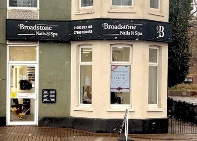 Entrance of Broadstone Nails and Spa in Poole, England, GB with modern signage and large windows.