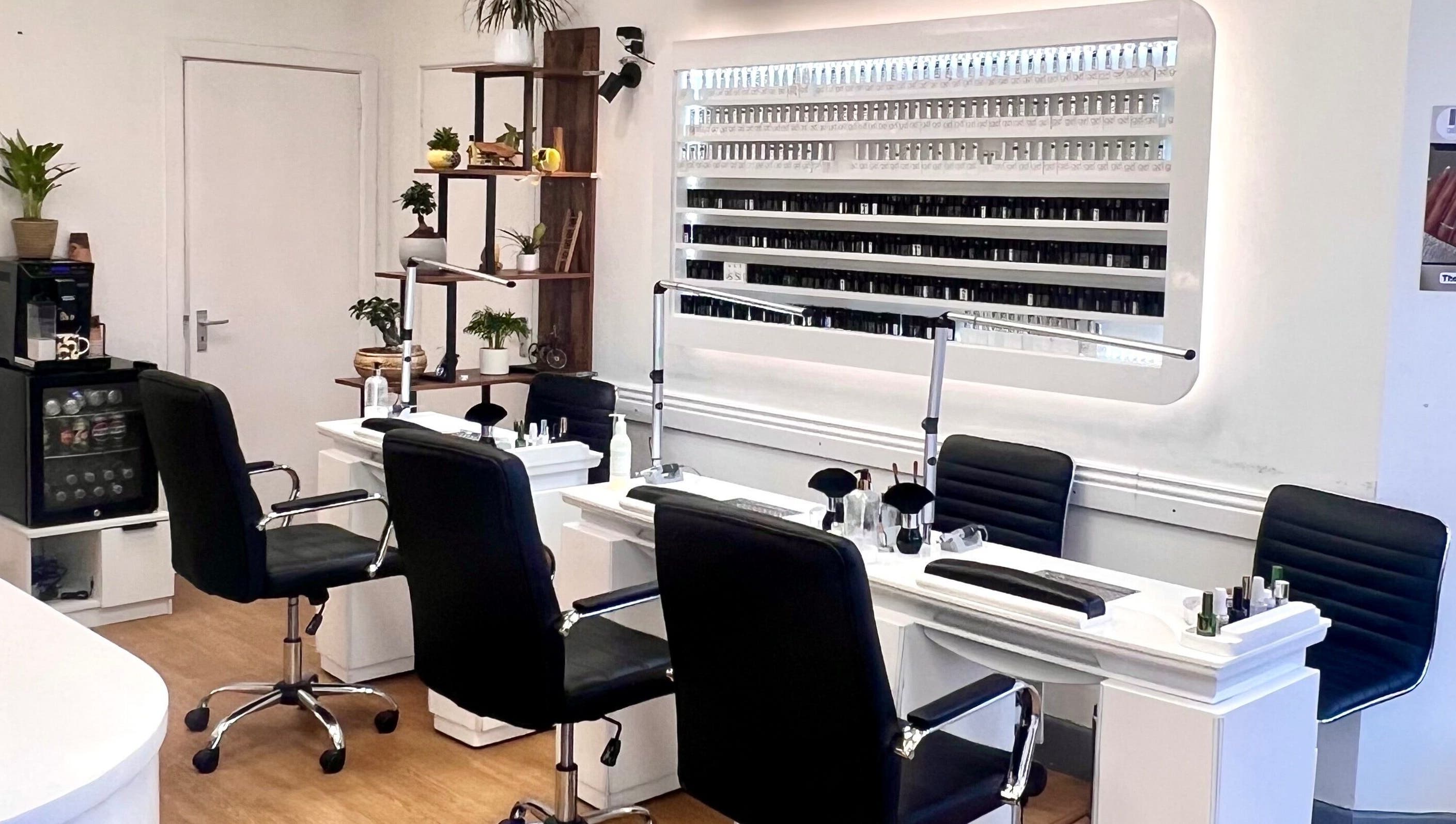 Elegant nail service area at Broadstone Nails and Spa in Poole, England, GB featuring stylish seating and polish display.