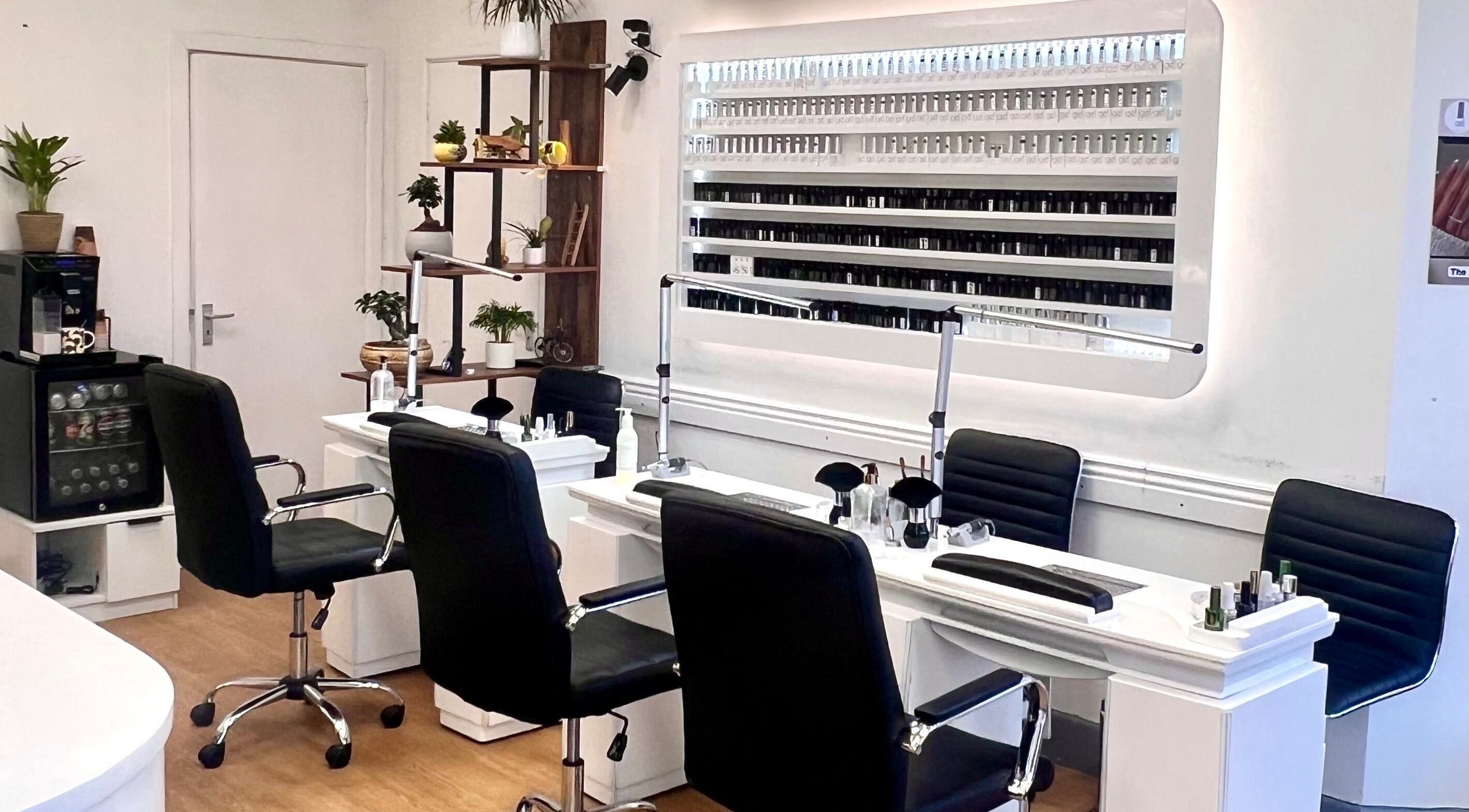 Elegant nail service area at Broadstone Nails and Spa in Poole, England, GB featuring stylish seating and polish display.