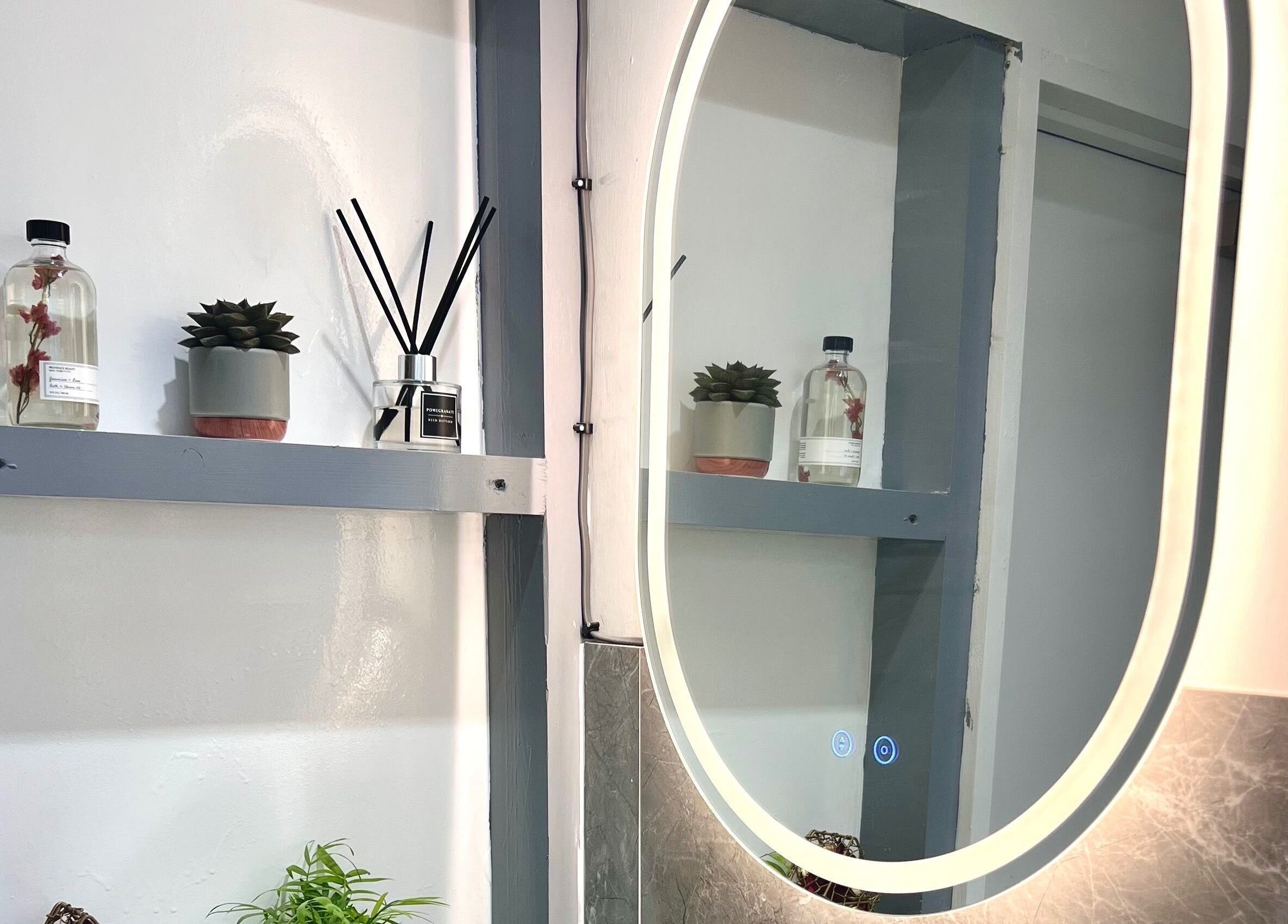 Chic shelf decor with plants and a mirror at Broadstone Nails and Spa, Poole, England, GB.