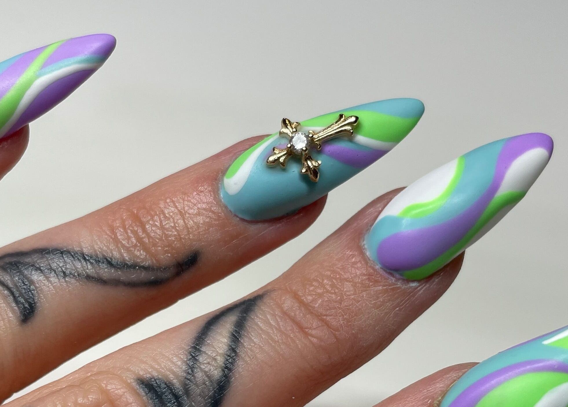 Colorful swirl nail design with jewel accent at A Dose of Sof, Vancouver, British Columbia, CA.