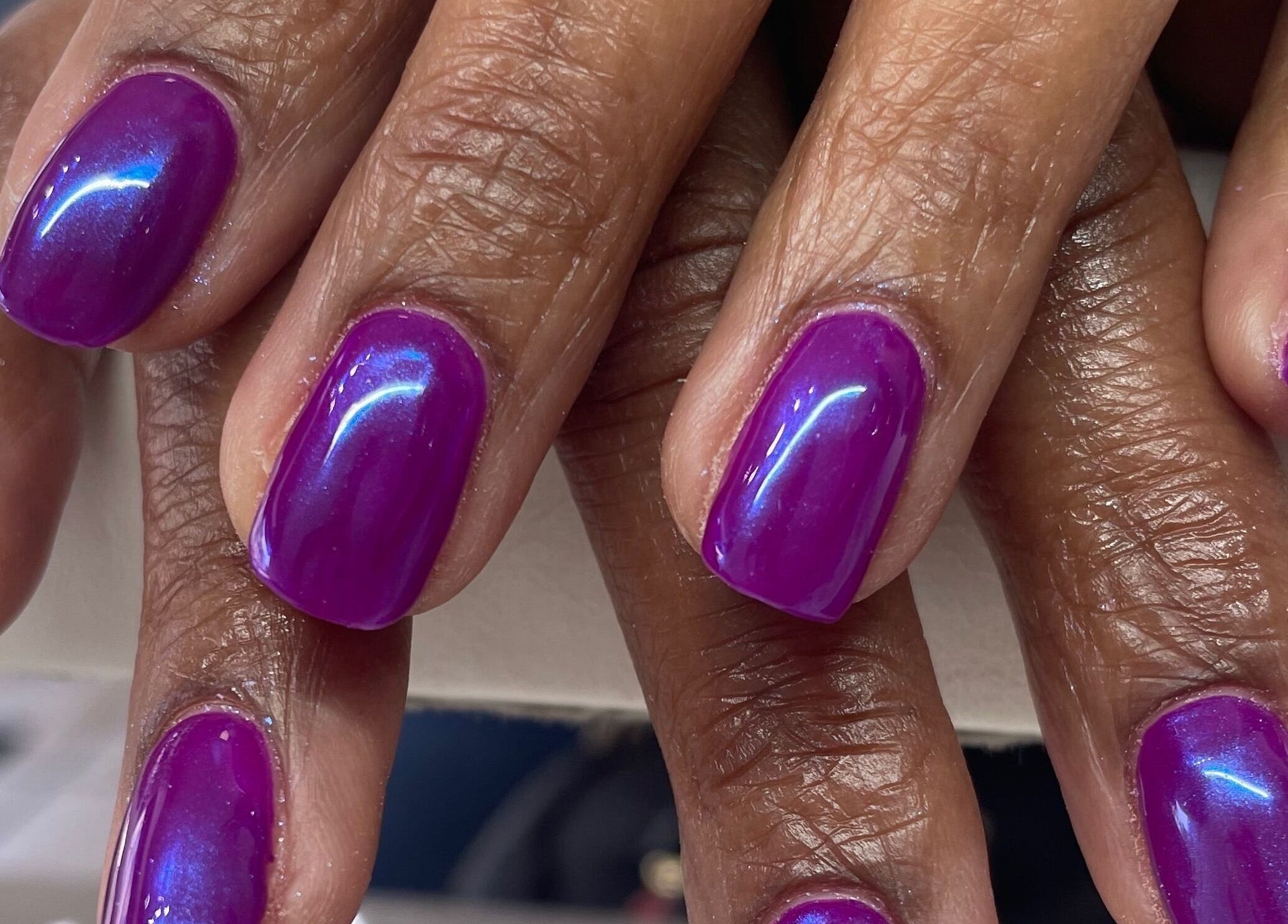 Vibrant purple manicured nails at A Dose of Sof, Vancouver, British Columbia, CA.