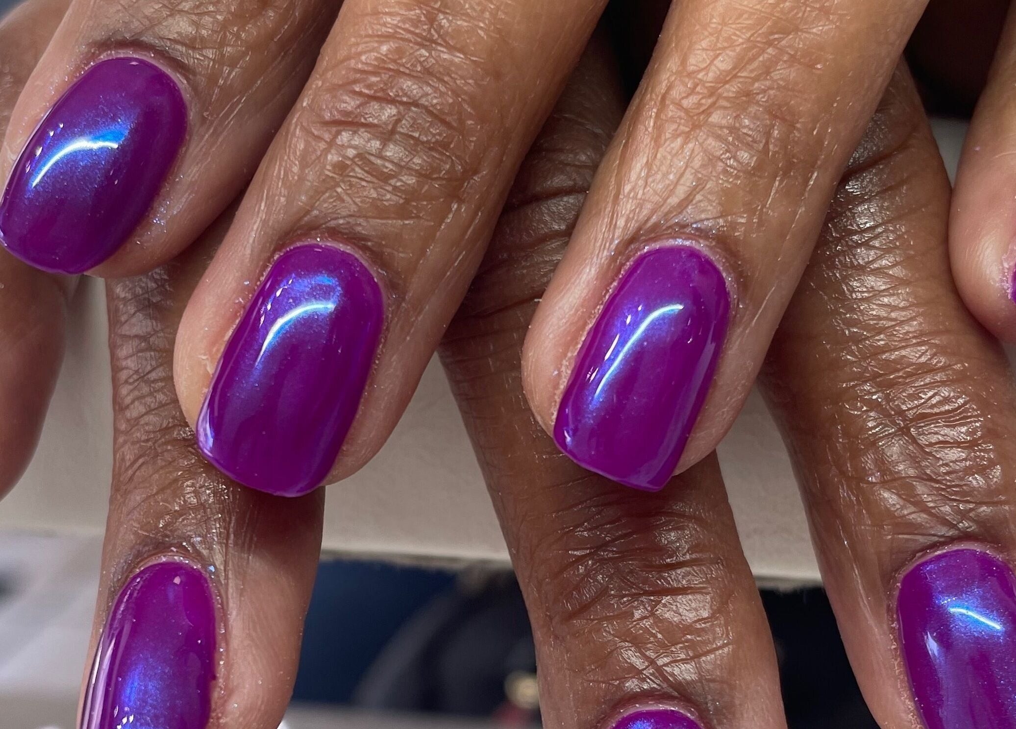 Vibrant purple manicured nails at A Dose of Sof, Vancouver, British Columbia, CA.