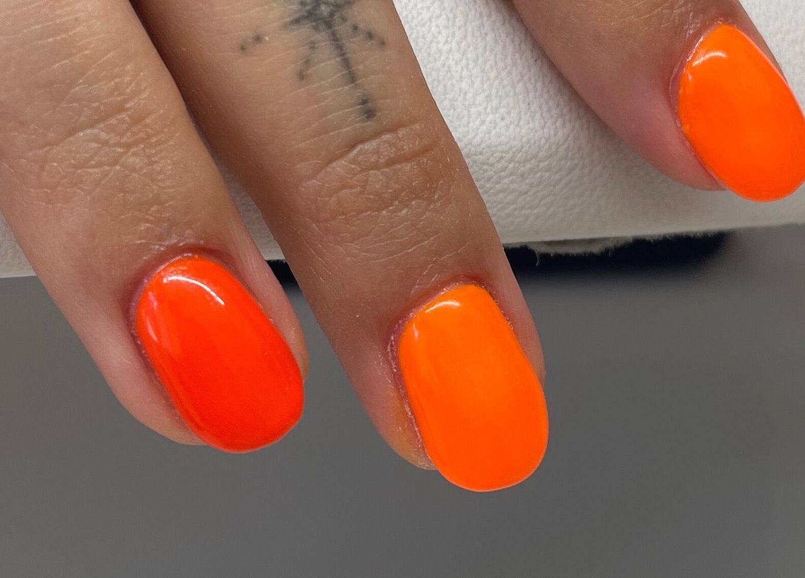 Bright neon orange nails at A Dose of Sof, Vancouver, British Columbia, CA.
