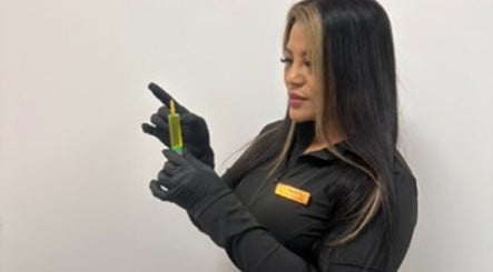 Aesthetician at Mitch Aesthetics London holding a syringe in Uxbridge, England, GB ready for a procedure.