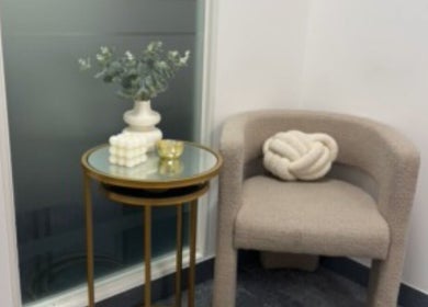 Elegant seating with beige chair and vase at Mitch Aesthetics London, Uxbridge, England, GB.