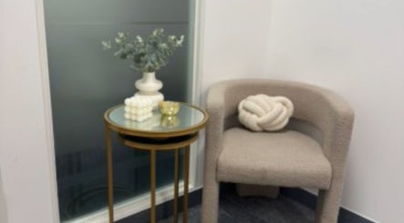 Elegant seating with beige chair and vase at Mitch Aesthetics London, Uxbridge, England, GB.