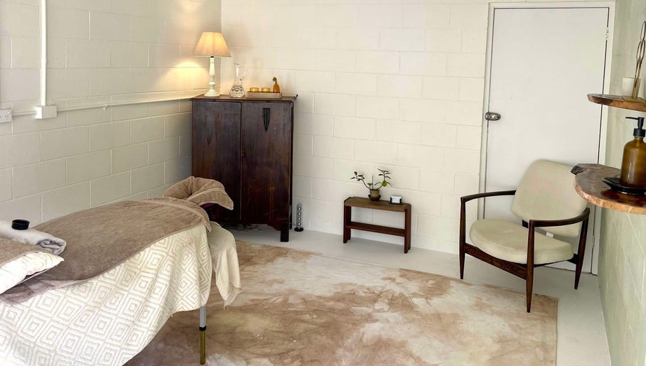 Relaxing massage room at Nurture, Byron Bay, New South Wales, AU. Cozy decor with comfortable bed and soft lighting.