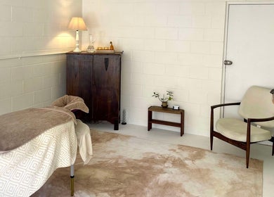 Relaxing massage room at Nurture, Byron Bay, New South Wales, AU. Cozy decor with comfortable bed and soft lighting.