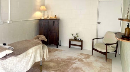 Relaxing massage room at Nurture, Byron Bay, New South Wales, AU. Cozy decor with comfortable bed and soft lighting.