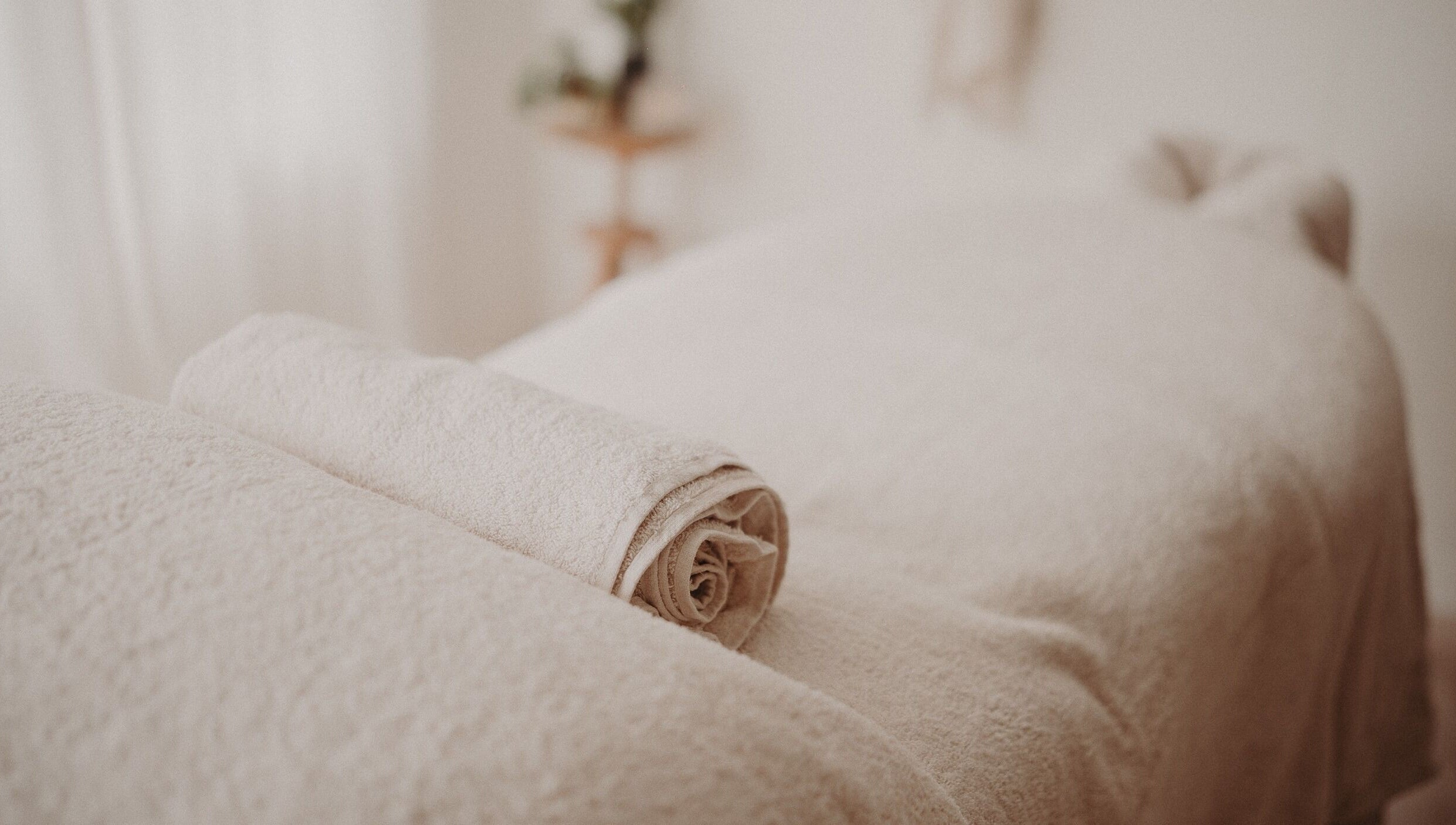Relaxing massage table setup at Nurture Massage, Byron Bay, New South Wales, AU, with folded towels.