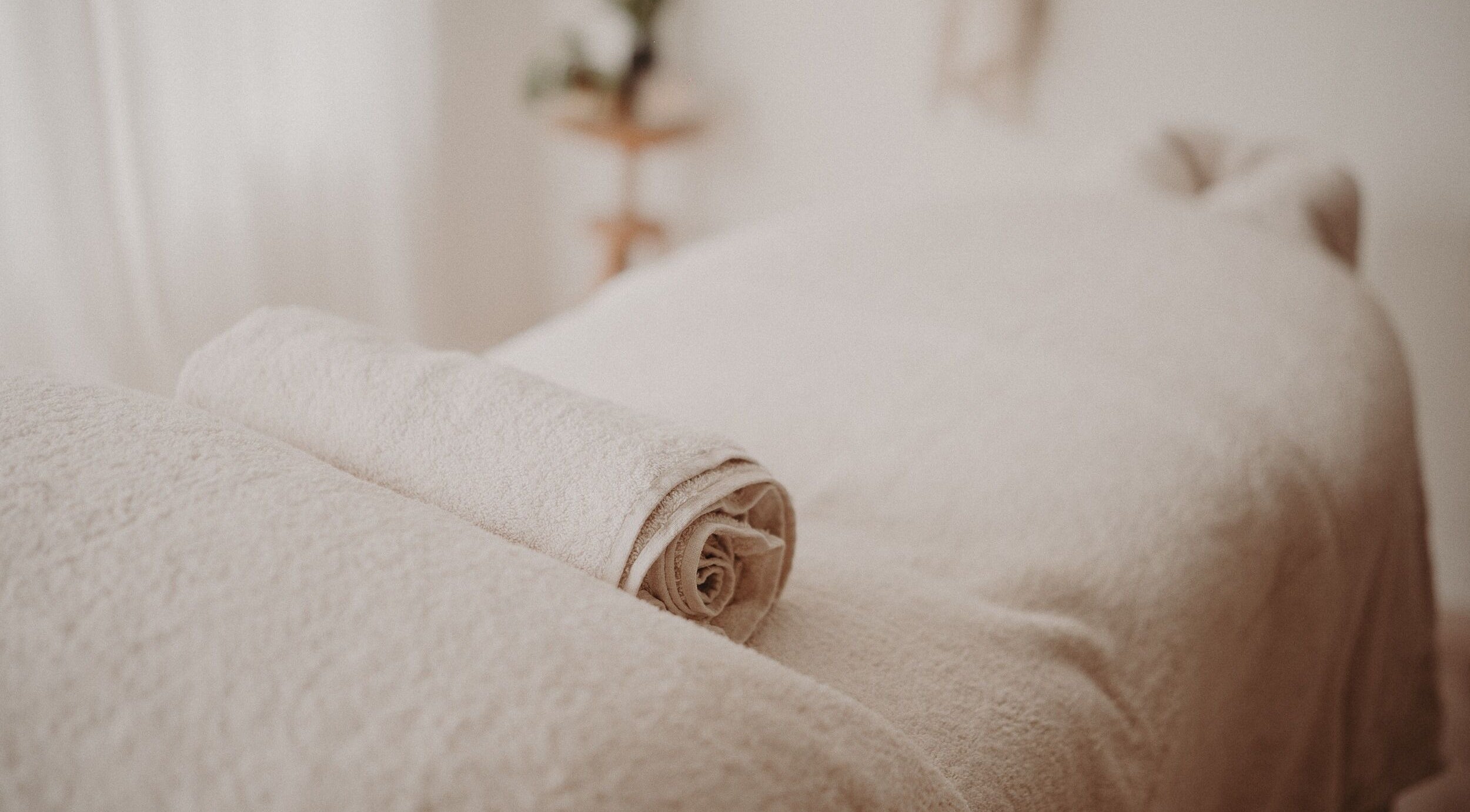 Relaxing massage table setup at Nurture Massage, Byron Bay, New South Wales, AU, with folded towels.