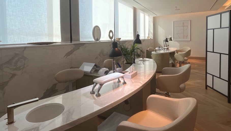 Sleek nail tables with modern chairs at AlSagheer Men Salon, Doha, Doha Municipality, QA, offering premium services.