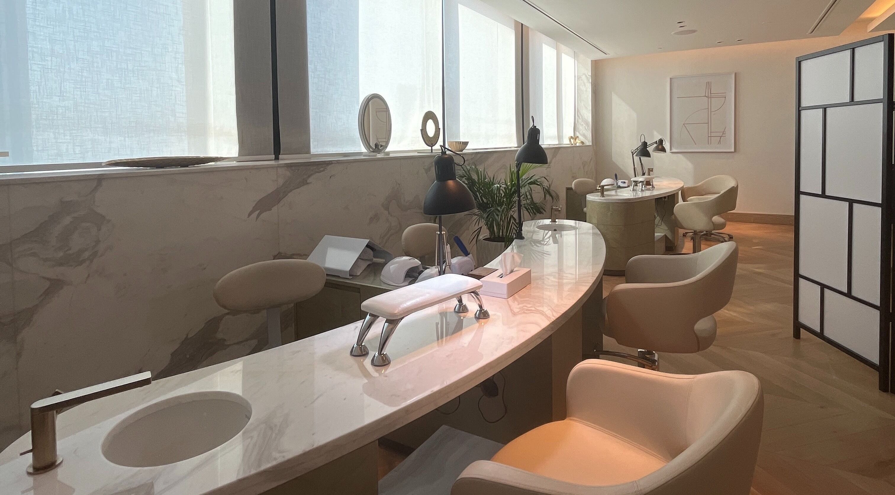 Sleek nail tables with modern chairs at AlSagheer Men Salon, Doha, Doha Municipality, QA, offering premium services.