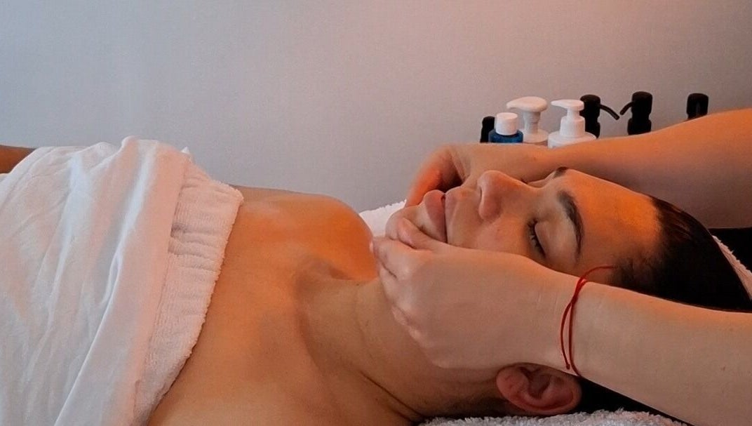 Calming facial massage at Golden Tree Holistic Therapies in Tuffley, England, GB. Relaxation and wellness focus.