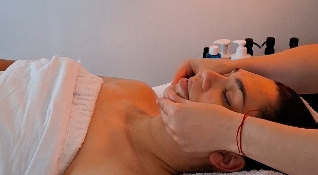 Calming facial massage at Golden Tree Holistic Therapies in Tuffley, England, GB. Relaxation and wellness focus.