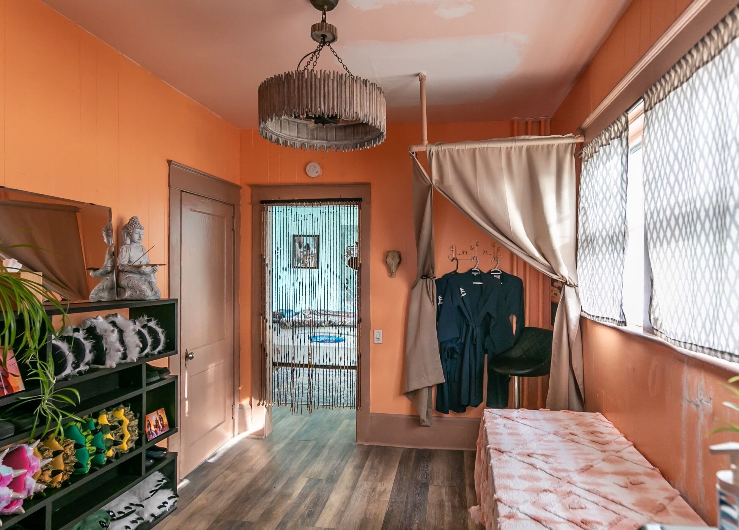 Cozy relaxation room at Middletown in Middletown, Rhode Island, US with robes, plants, and soft lighting.