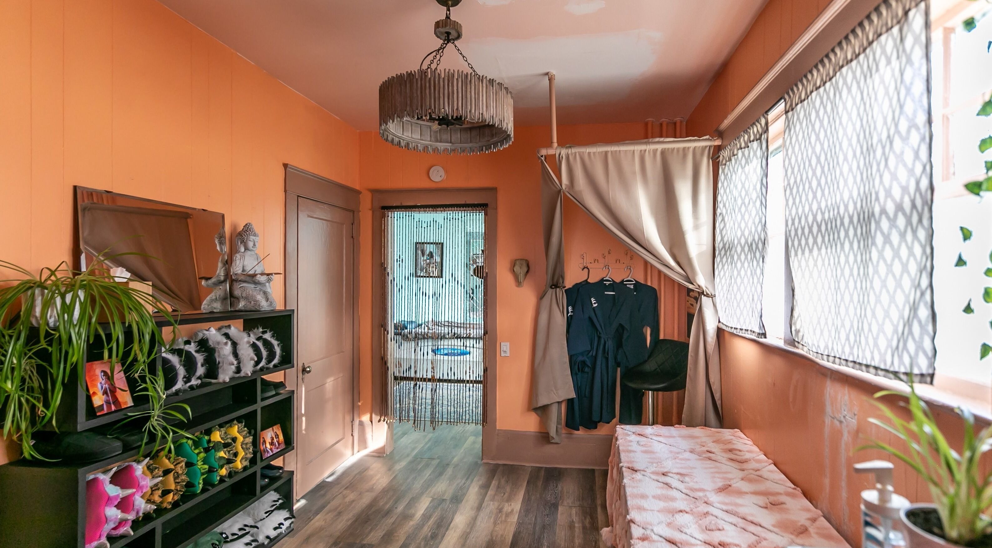 Cozy relaxation room at Middletown in Middletown, Rhode Island, US with robes, plants, and soft lighting.