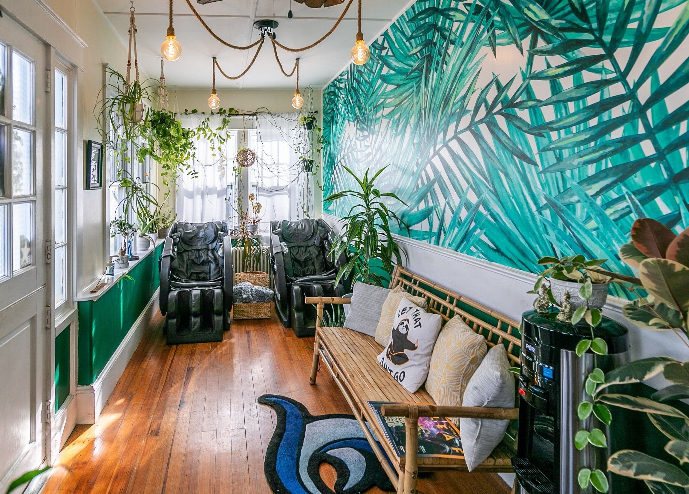 Relaxing lounge at Middletown with plant decor and massage chairs, Rhode Island, US.