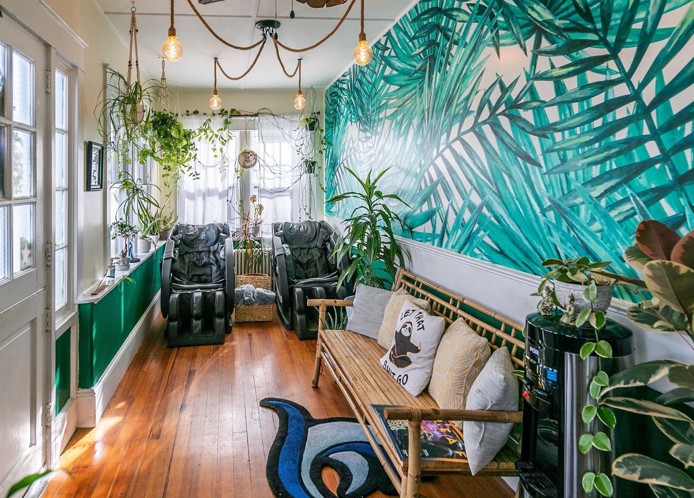 Relaxing lounge at Middletown with plant decor and massage chairs, Rhode Island, US.