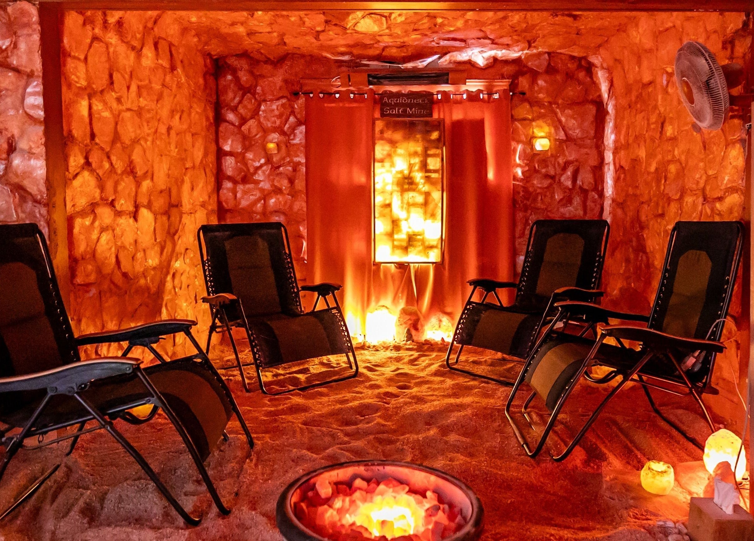 Peaceful salt therapy room at Middletown, Rhode Island, US, featuring relaxing lounge chairs in a warm ambiance.