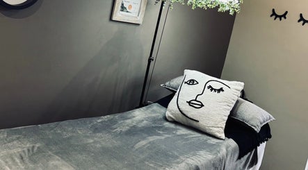 Cozy treatment bed at MS Lashes, Olifantsfontein, Gauteng, ZA with artistic pillow and serene decor.