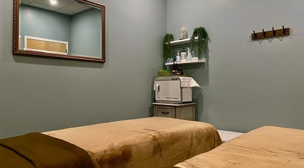 Tranquil massage room at Chhaya Thai Spa Danvers, Danvers, Massachusetts, US with beds and calming decor.